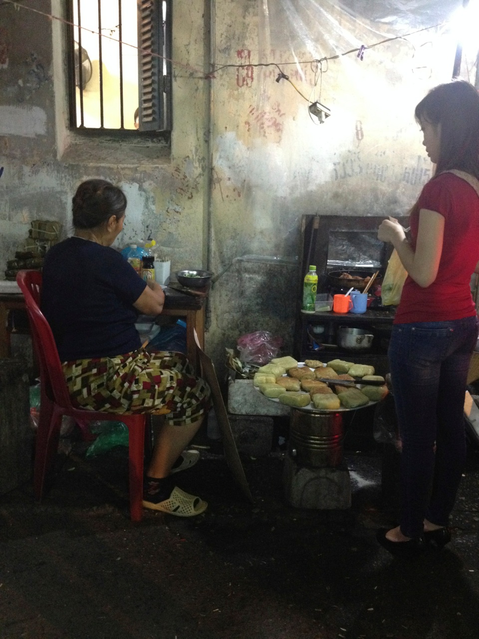 Woman cooking street food in the Old Quarter.